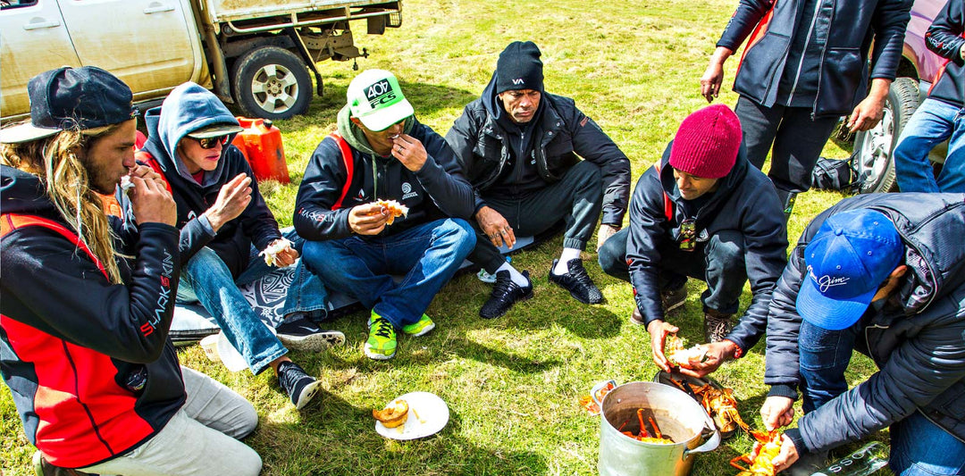 Group of people in a circle wearing Sharkskin Jackets to stay warm