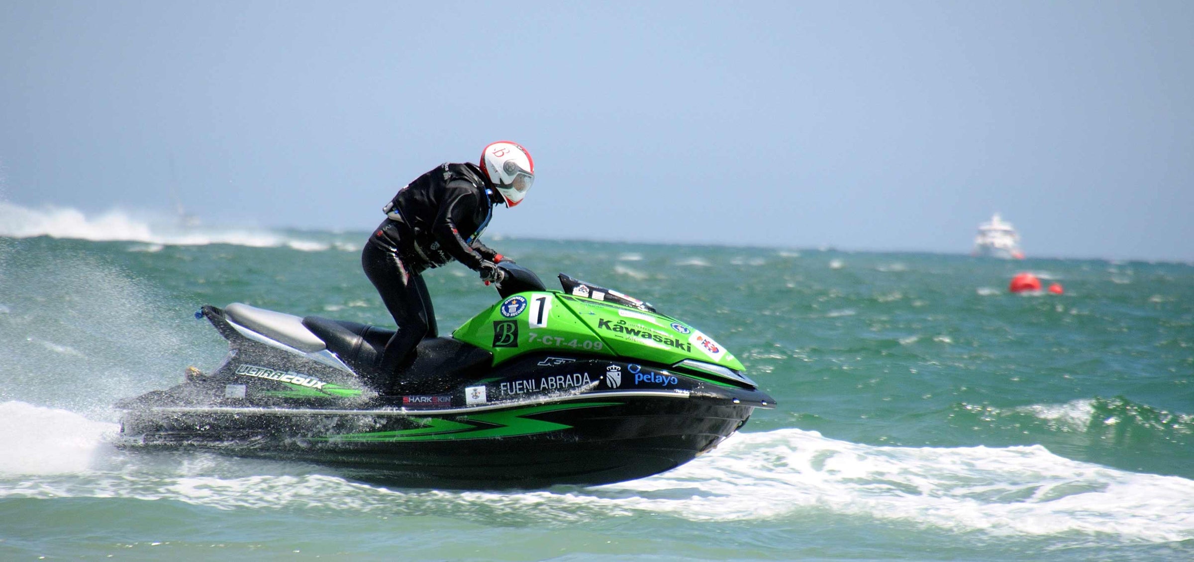 jestski rider in surf wearing Sharkskin top and pants